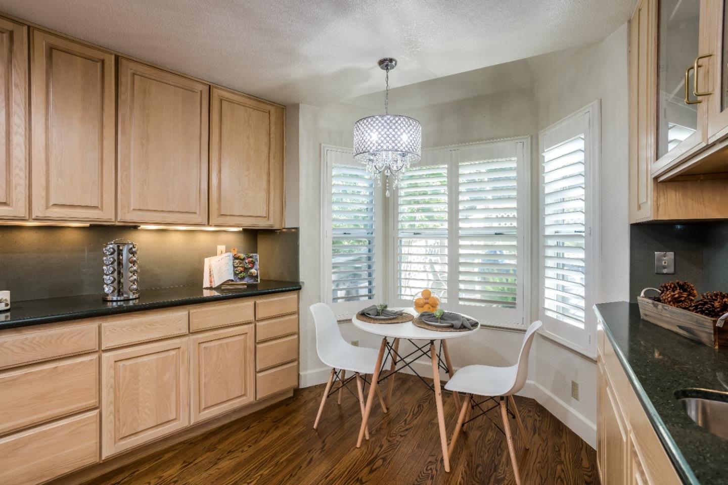 8898 Skyline Boulevard Oakland, CA 94611 - Photo 13 of 35 a kitchen with granite countertop white cabinets and white appliances