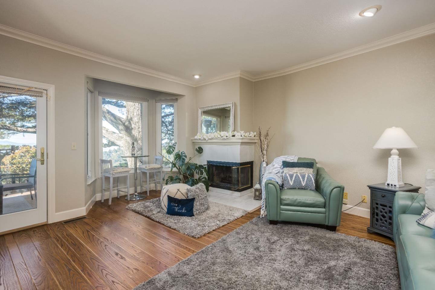 8898 Skyline Boulevard Oakland, CA 94611 - Photo 15 of 35 a living room with furniture and a fireplace