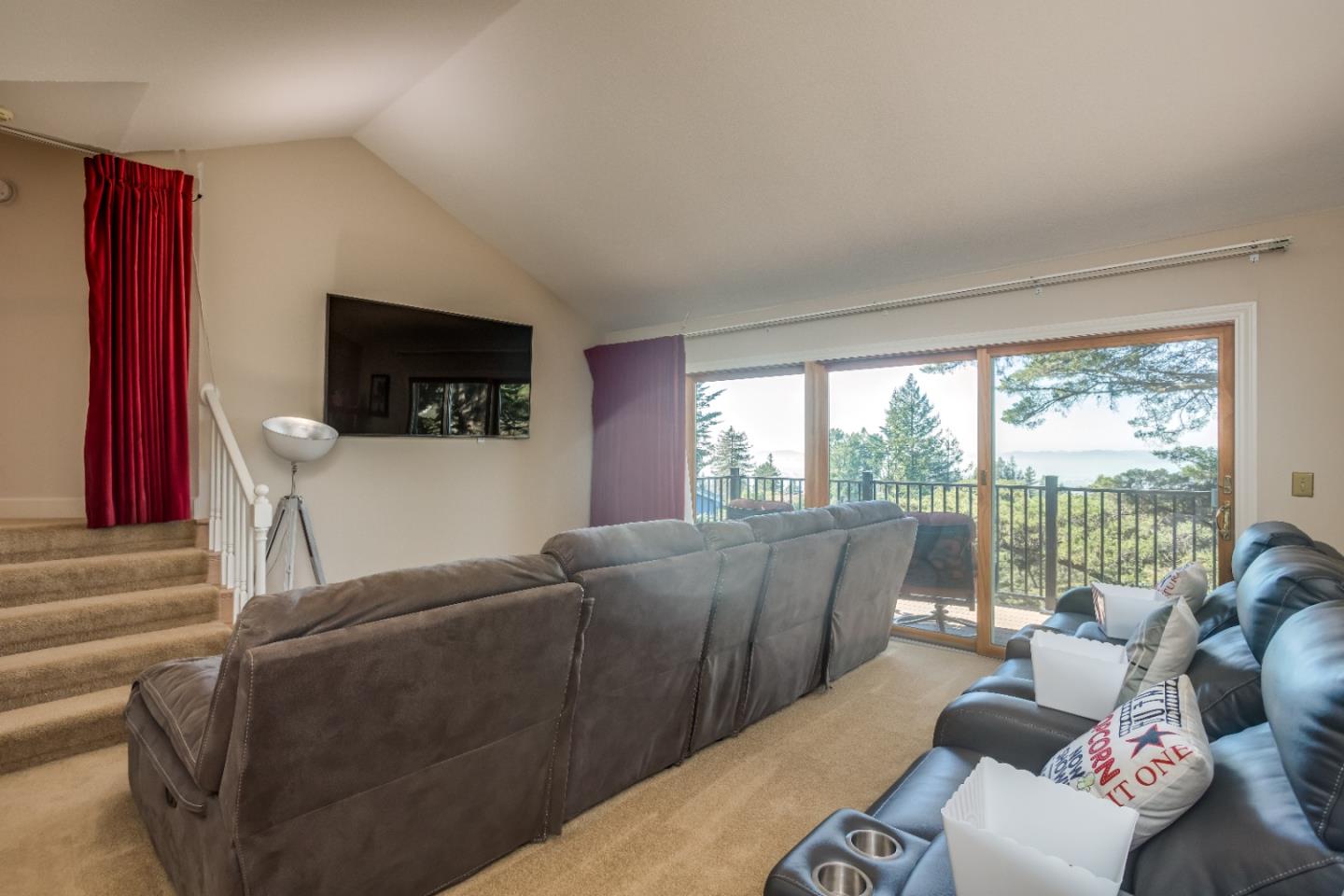 8898 Skyline Boulevard Oakland, CA 94611 - Photo 18 of 35 a living room with furniture a flat screen tv and a floor to ceiling window