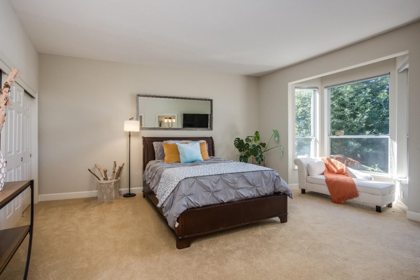 8898 Skyline Boulevard Oakland, CA 94611 - Photo 22 of 35 a bedroom with a bed and large window