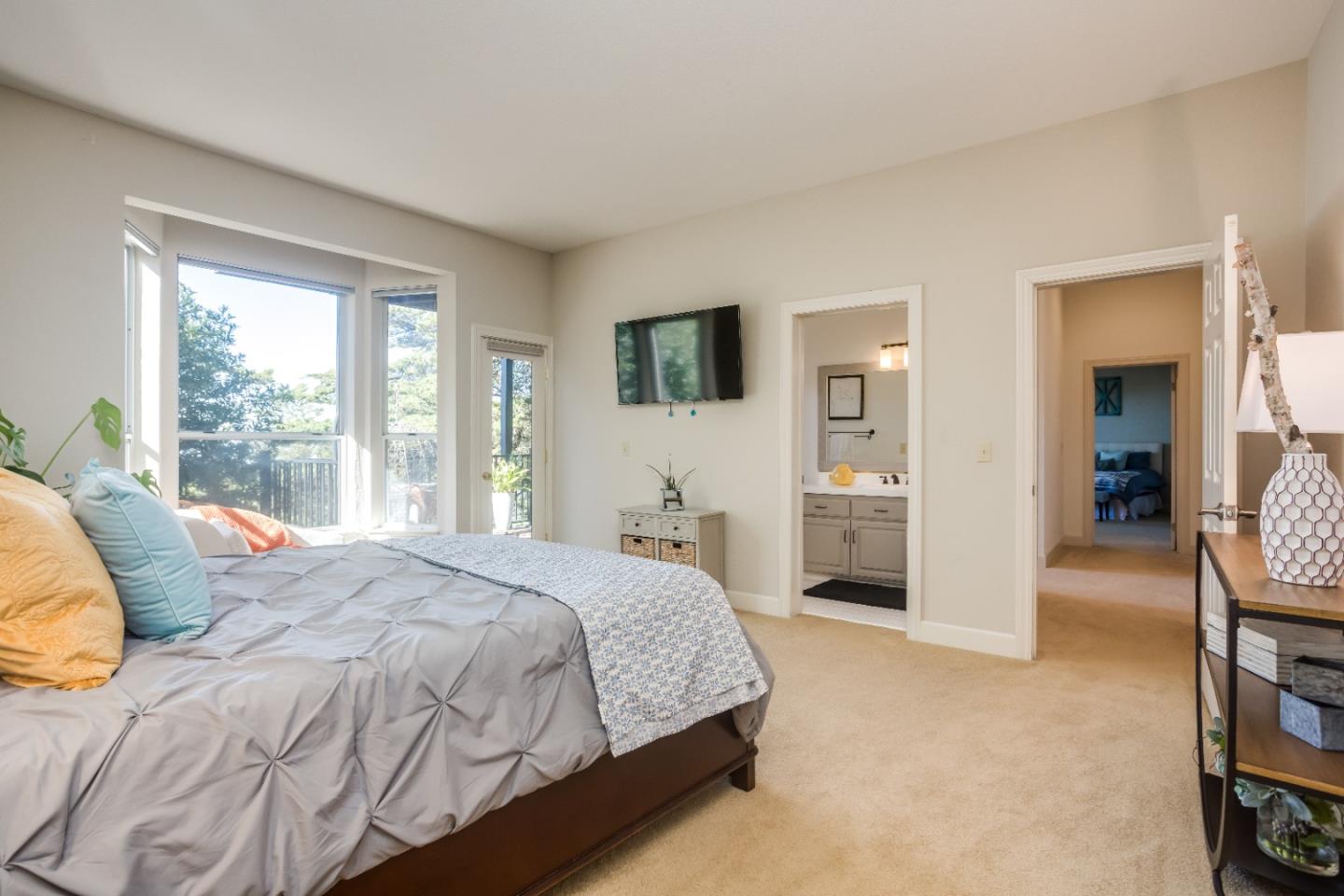 8898 Skyline Boulevard Oakland, CA 94611 - Photo 23 of 35 a bedroom with a bed and a television