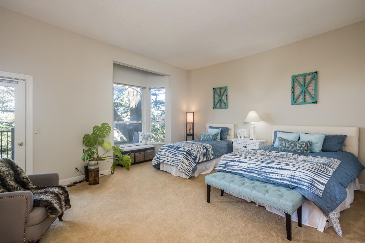 8898 Skyline Boulevard Oakland, CA 94611 - Photo 25 of 35 a bedroom with bed couch and window