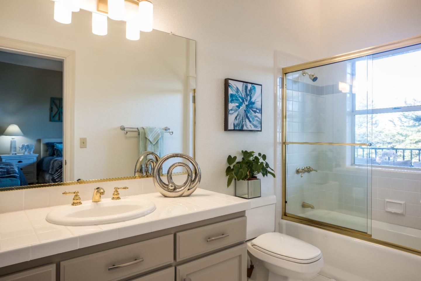 8898 Skyline Boulevard Oakland, CA 94611 - Photo 27 of 35 a bathroom with a sink a toilet and shower