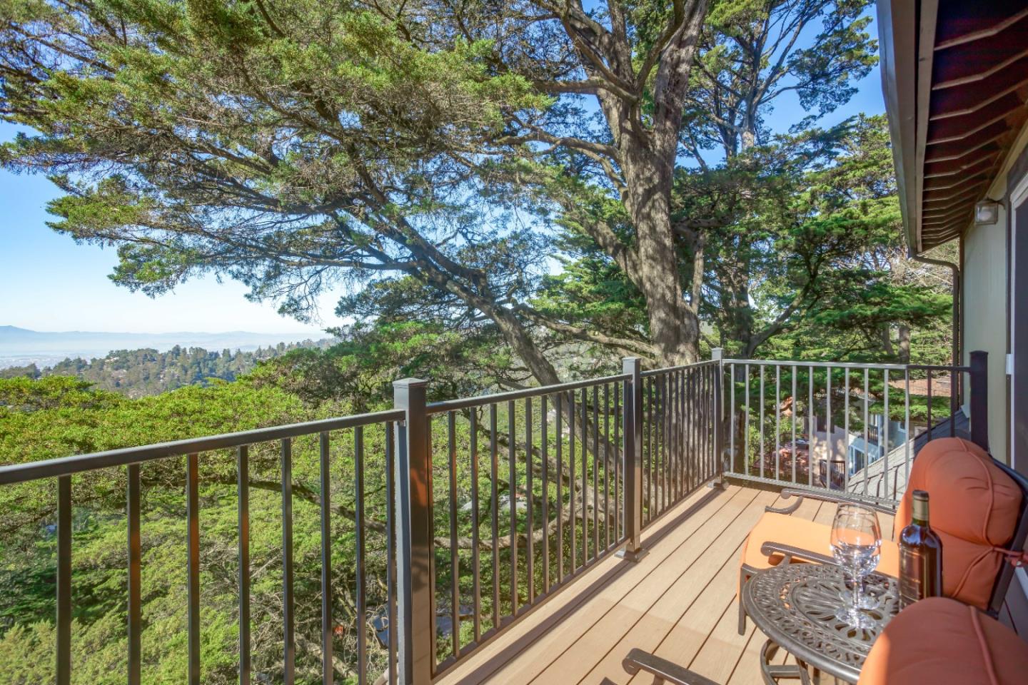 8898 Skyline Boulevard Oakland, CA 94611 - Photo 31 of 35 a view of a balcony with wooden floor and fence
