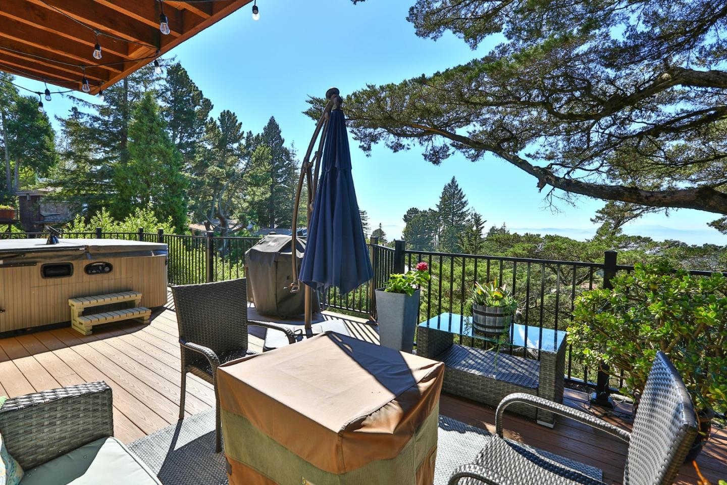 8898 Skyline Boulevard Oakland, CA 94611 - Photo 4 of 35 a view of a patio with a table chairs and a backyard