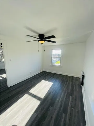 a view of wooden floor and windows in a room