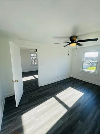 a view of an empty room and wooden floor