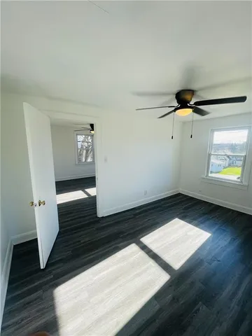 a view of an empty room and wooden floor