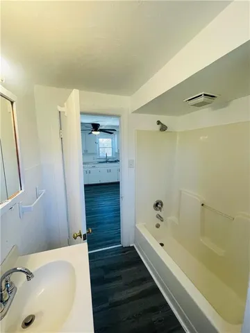 a bathroom with a bathtub and a sink