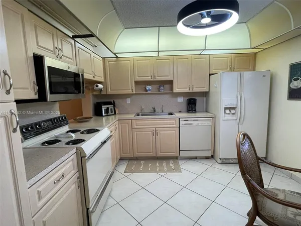 a kitchen with cabinets stainless steel appliances and a counter space