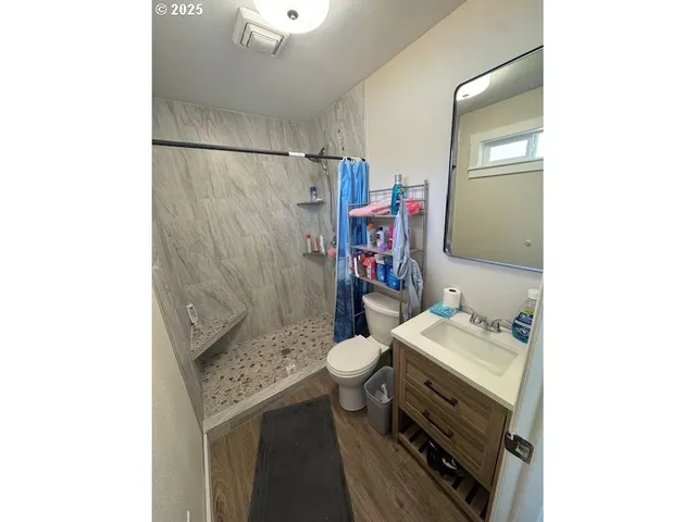 a bathroom with a sink toilet and shower