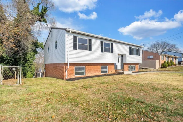 a view of a house with backyard and sitting area