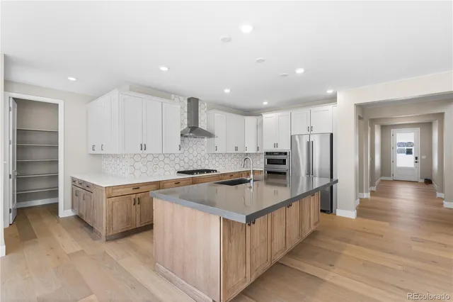 a kitchen with stainless steel appliances granite countertop a table and a refrigerator