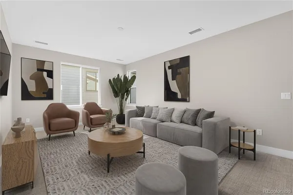 a living room with furniture potted plant and window