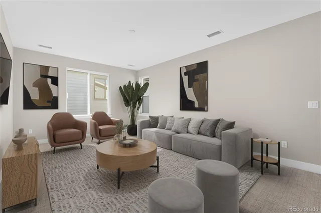 a living room with furniture potted plant and window