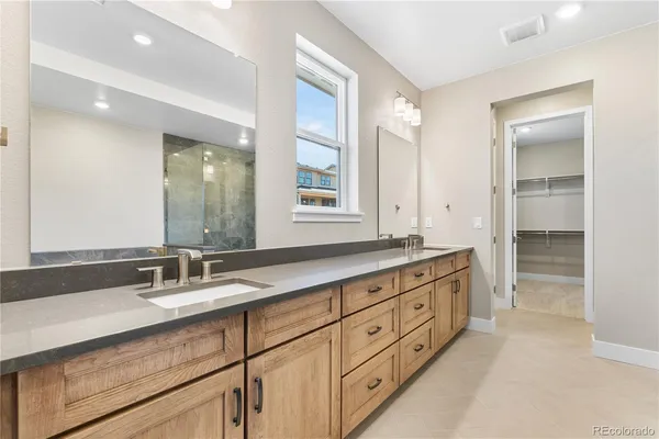 a bathroom with double sink and a mirror