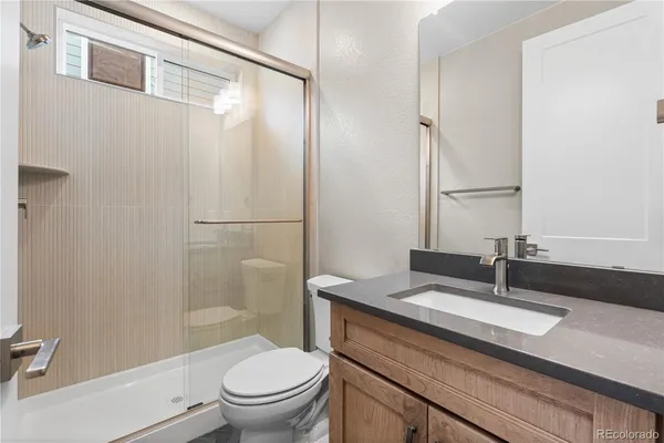 a bathroom with a sink a toilet and a mirror