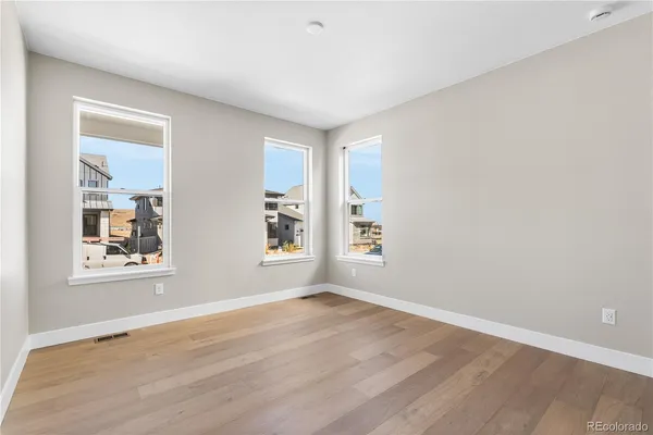 an empty room with windows and closet