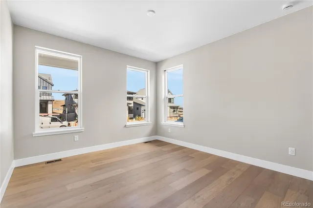 an empty room with windows and closet