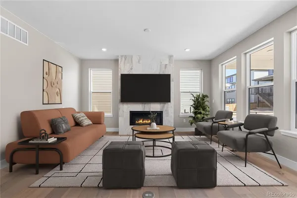 a living room with furniture a fireplace and a flat screen tv