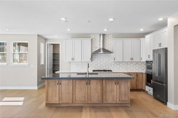 a kitchen with stainless steel appliances granite countertop a stove a sink and a refrigerator