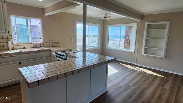 a kitchen with a wooden floor and a window