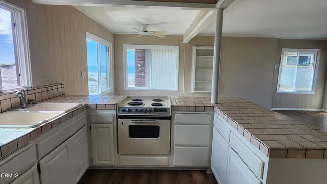 a kitchen that has a sink and a stove