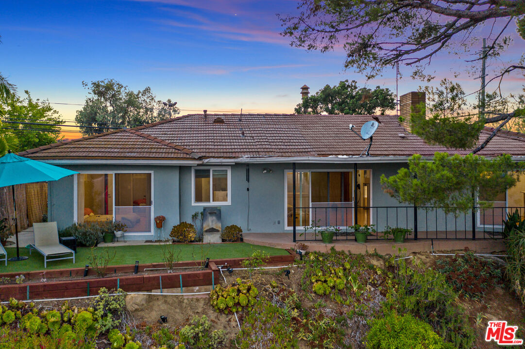 2438 Roscomare Road Los Angeles, CA 90077 - Photo 11 of 17 a front view of a house with a garden and plants