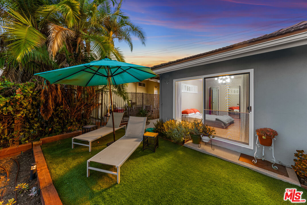 2438 Roscomare Road Los Angeles, CA 90077 - Photo 12 of 17 a backyard of a house with table and chairs