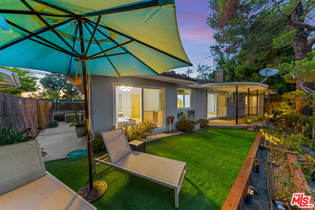 2438 Roscomare Road Los Angeles, CA 90077 - Photo 13 of 17 a view of an house with backyard porch and sitting area