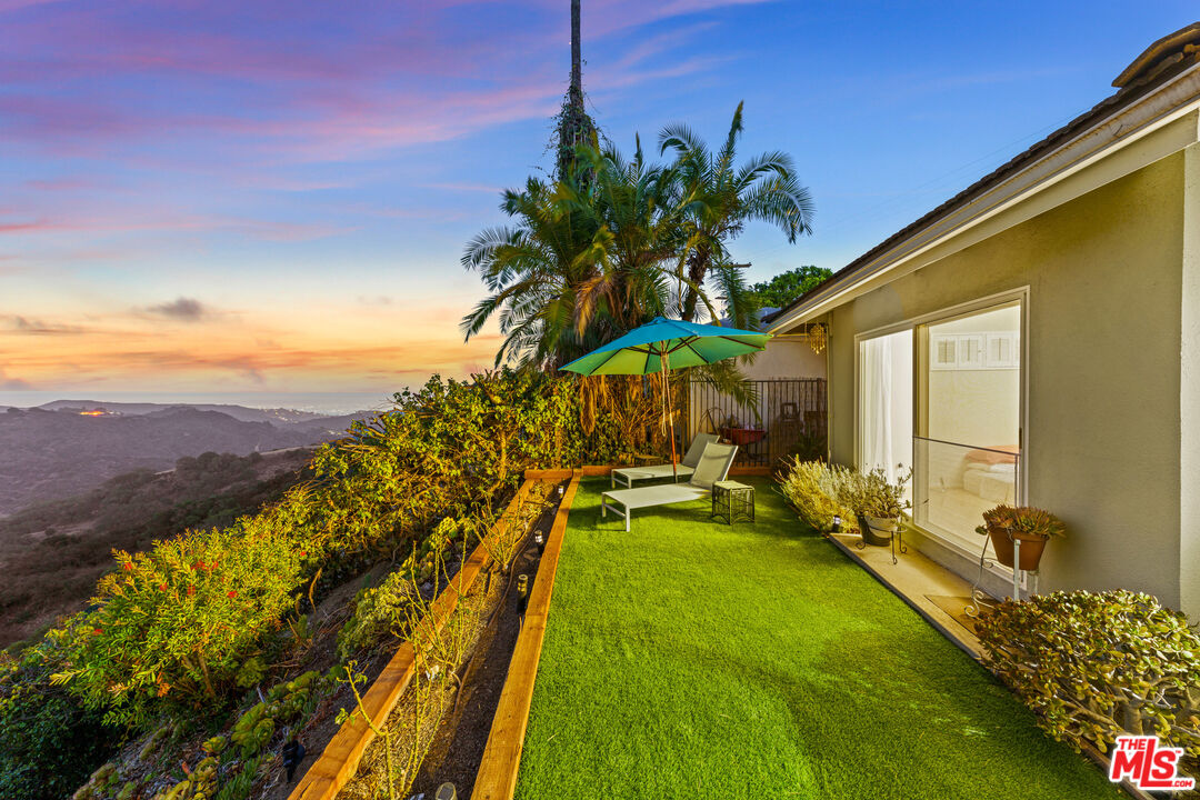 2438 Roscomare Road Los Angeles, CA 90077 - Photo 14 of 17 a view of swimming pool with a table and chairs