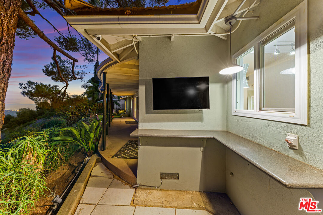 2438 Roscomare Road Los Angeles, CA 90077 - Photo 17 of 17 a bathroom with a sink and mirror