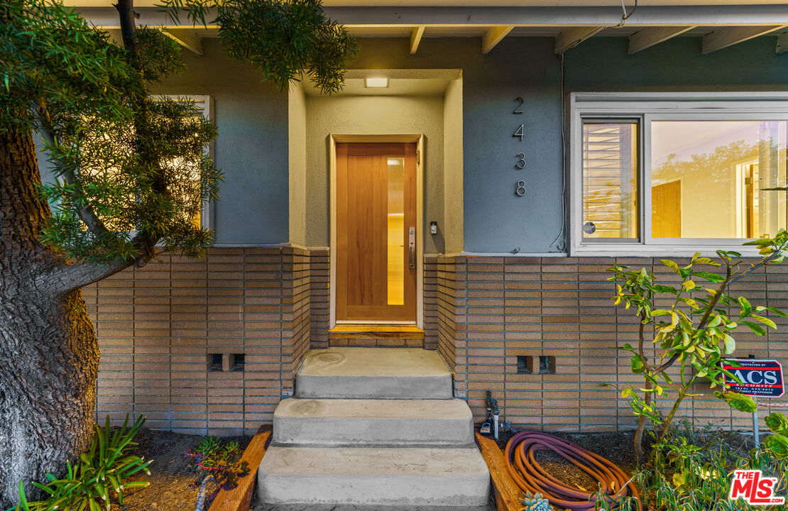 2438 Roscomare Road Los Angeles, CA 90077 - Photo 7 of 17 a front view of a house with a garden