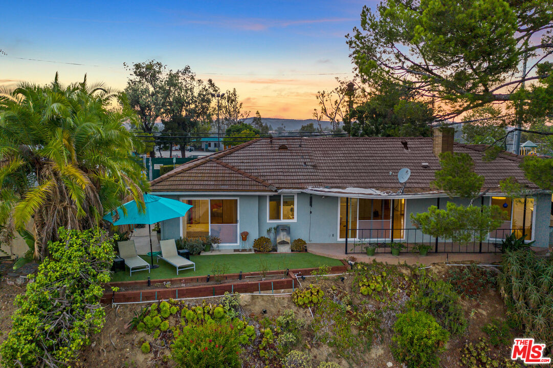 2438 Roscomare Road Los Angeles, CA 90077 - Photo 8 of 17 a front view of a house with a garden