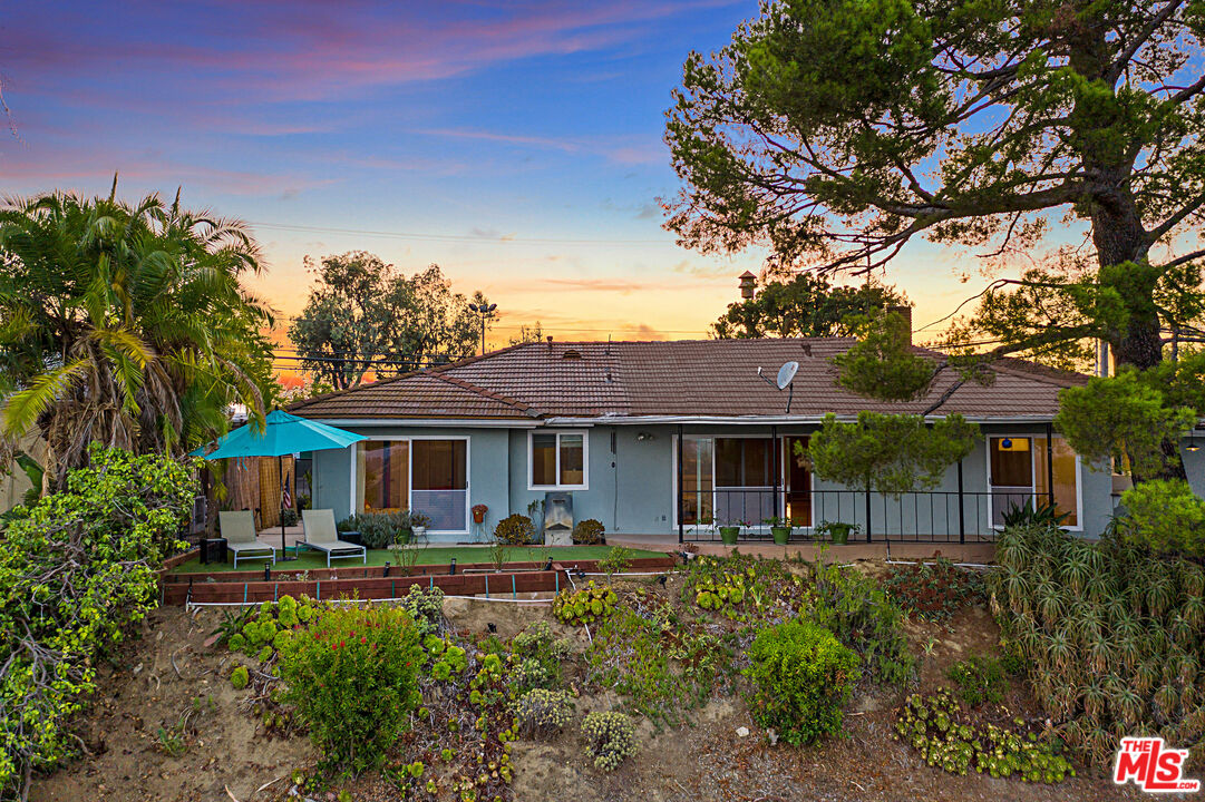2438 Roscomare Road Los Angeles, CA 90077 - Photo 9 of 17 a front view of a house with a yard