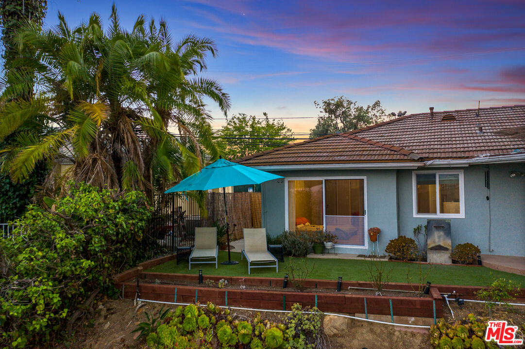 2438 Roscomare Road Los Angeles, CA 90077 - Photo 10 of 17 a front view of a house with garden