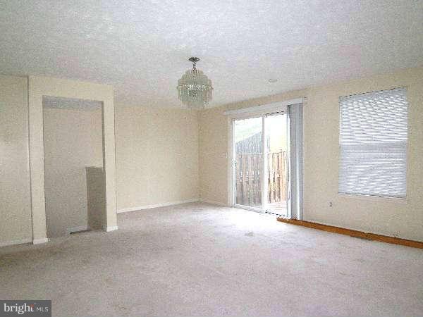 525 Ridgefield Avenue Stephens City, VA 22655 - Photo 15 of 26 an empty room with chandelier fan and windows