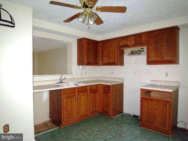 525 Ridgefield Avenue Stephens City, VA 22655 - Photo 18 of 26 a kitchen with stainless steel appliances a sink cabinets and wooden floor
