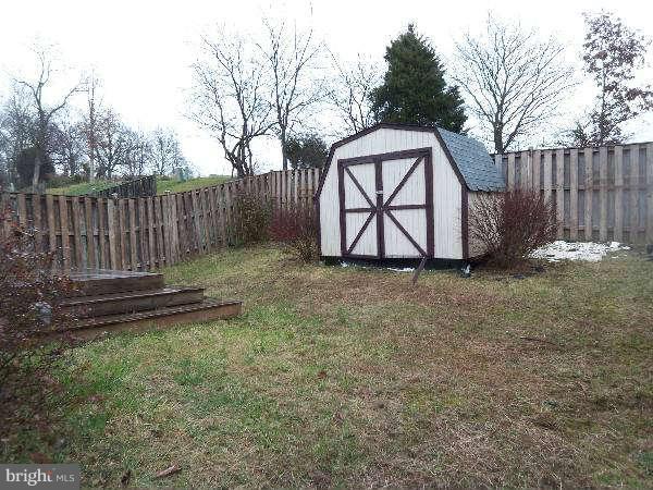 525 Ridgefield Avenue Stephens City, VA 22655 - Photo 5 of 26 a view of backyard with wooden fence and a swing