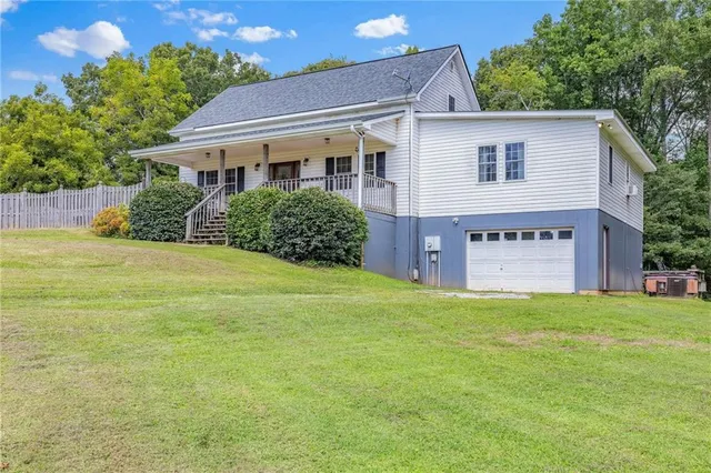 a living room with furniture a ceiling fan and a window