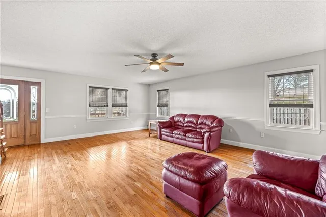 a view of an empty room with window and closet area
