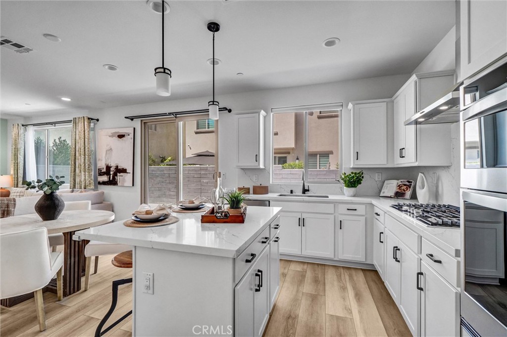 653 Longhorn Way Rancho Mission Viejo, CA 92694 - Photo 12 of 30 a kitchen with a sink stove and cabinets