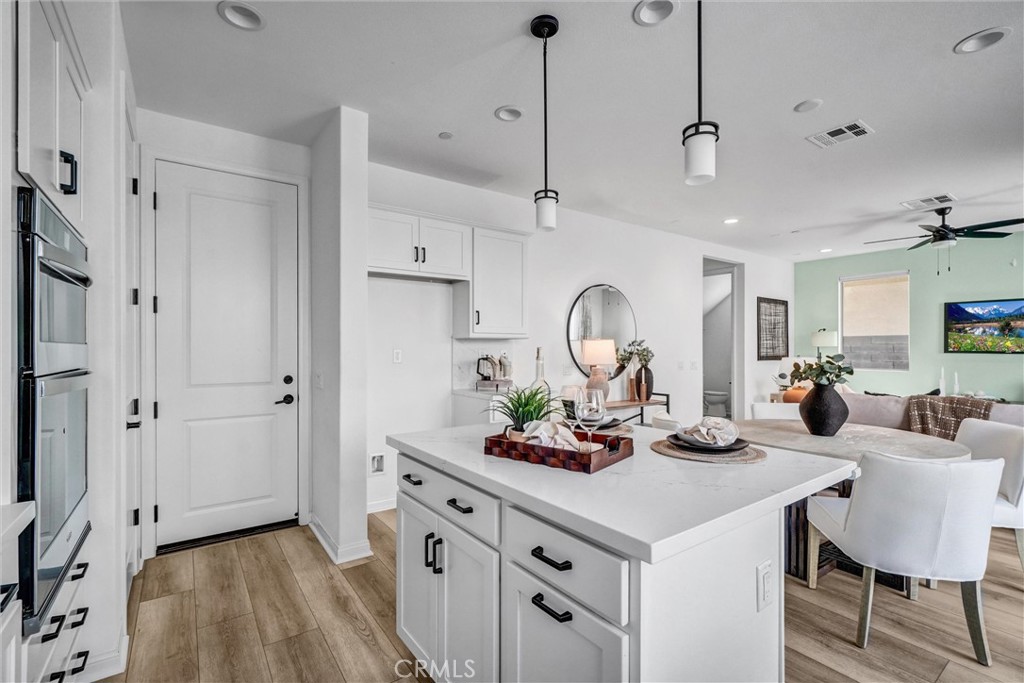 653 Longhorn Way Rancho Mission Viejo, CA 92694 - Photo 13 of 30 a view of a dining room and a kitchen with a table chairs