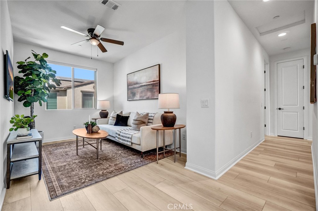 653 Longhorn Way Rancho Mission Viejo, CA 92694 - Photo 14 of 30 a living room with furniture and a chandelier