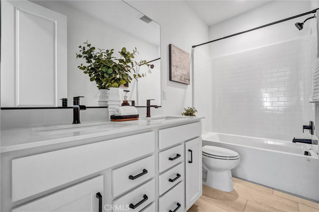653 Longhorn Way Rancho Mission Viejo, CA 92694 - Photo 17 of 30 a bathroom with a sink a toilet and a mirror