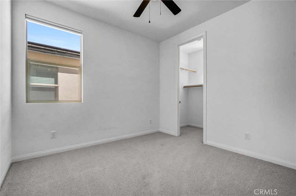 653 Longhorn Way Rancho Mission Viejo, CA 92694 - Photo 20 of 30 an empty room with a ceiling fan and a window