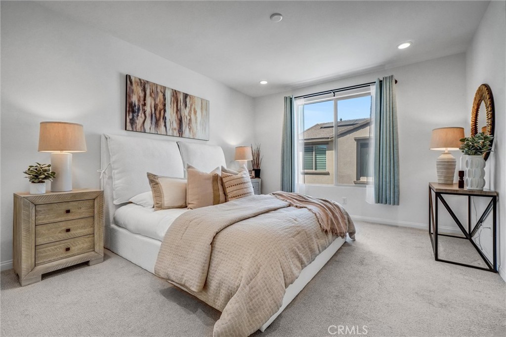 653 Longhorn Way Rancho Mission Viejo, CA 92694 - Photo 22 of 30 a bedroom with a bed and a chandelier