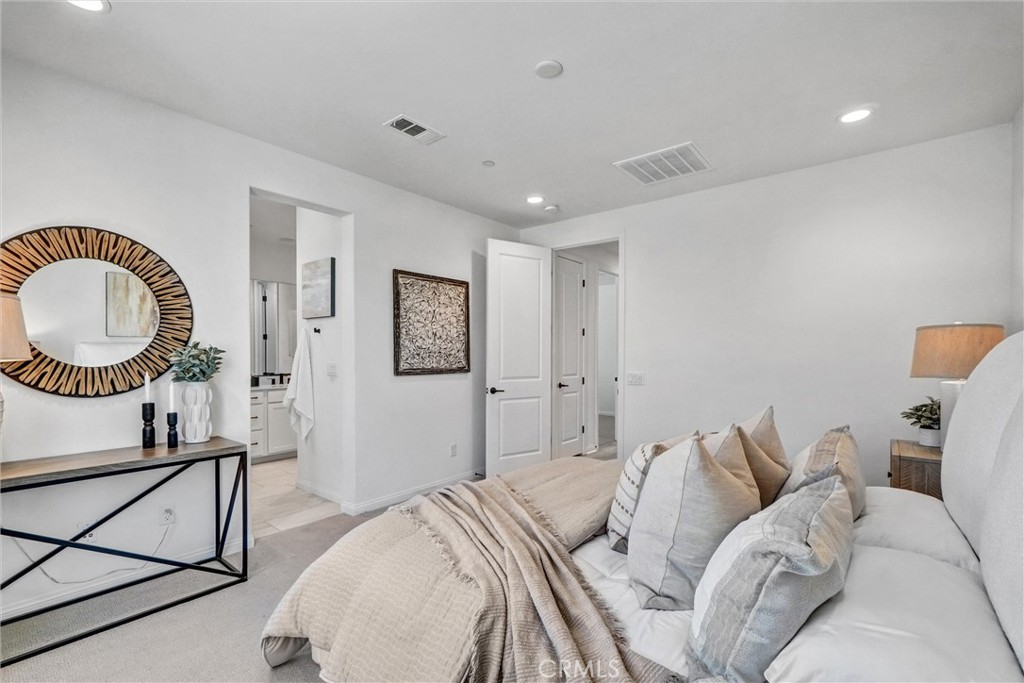 653 Longhorn Way Rancho Mission Viejo, CA 92694 - Photo 23 of 30 a bed room with a bed a mirror and a window