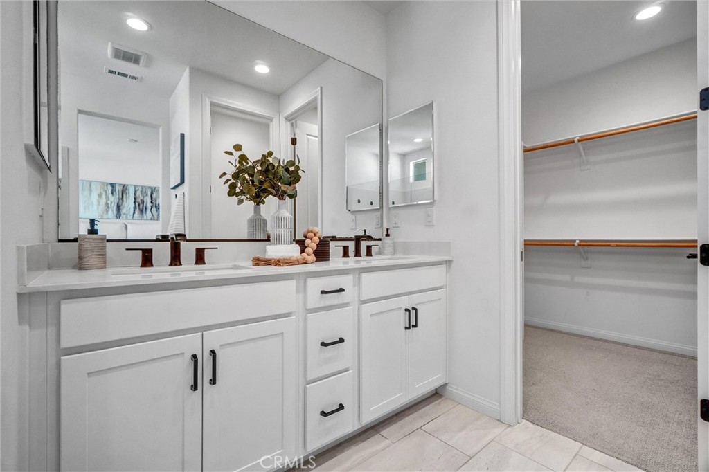 653 Longhorn Way Rancho Mission Viejo, CA 92694 - Photo 24 of 30 a bathroom with a sink vanity and mirror