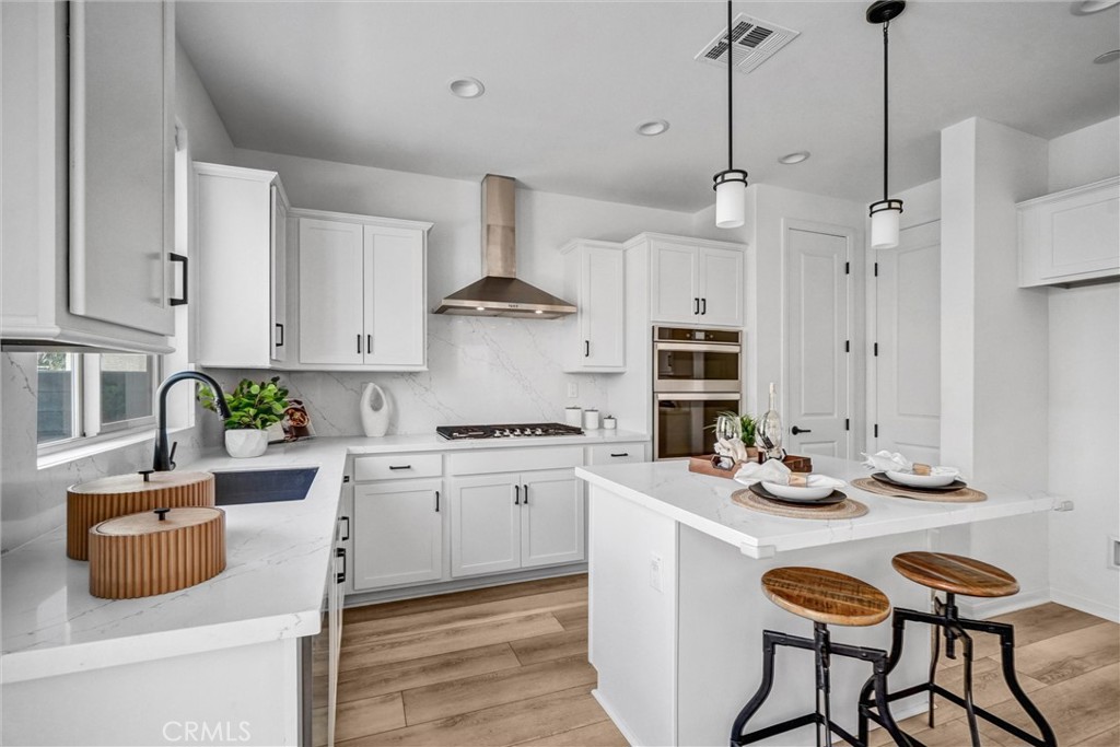 653 Longhorn Way Rancho Mission Viejo, CA 92694 - Photo 10 of 30 a kitchen with stainless steel appliances granite countertop a stove a sink and a refrigerator